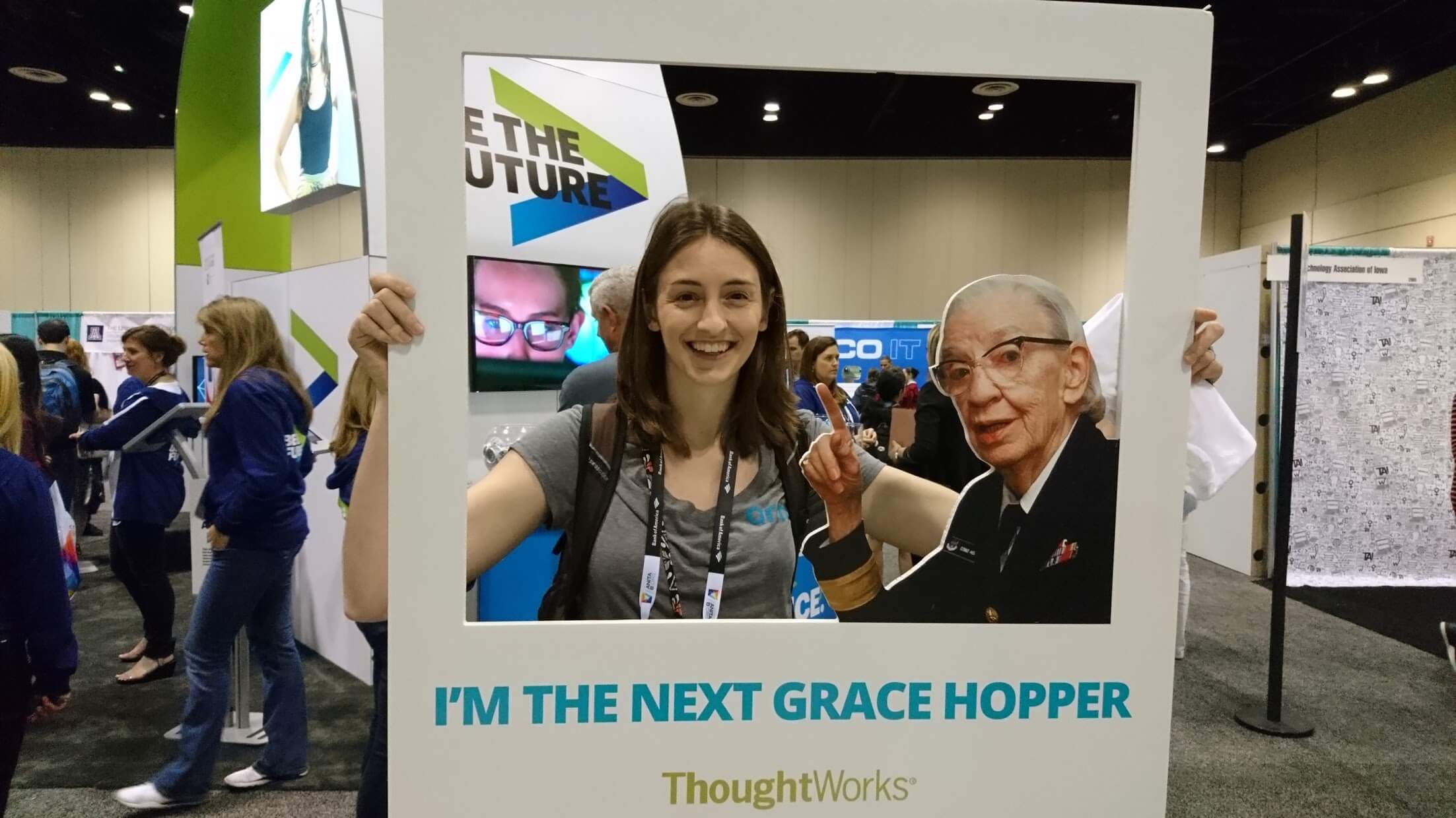 Smiling person holding a Grace Hopper frame.